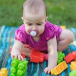 baby-play-whit-toy-block-outdoors-picture-id1209622820