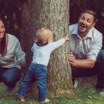 happy-family-with-a-cute-baby-playing-hide-and-seek-in-the-woods-picture-id1284958758