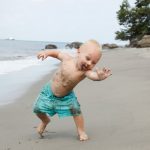 young-toddler-covered-in-mud-playing-on-a-beach-picture-id176022988